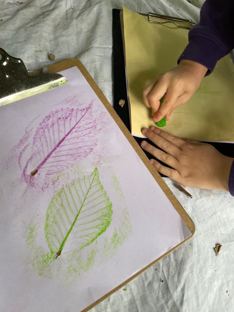 child doing a leaf rubbing